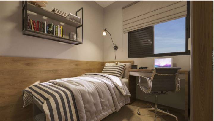 Quarto com cama individual e bancada de estudos